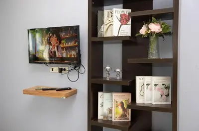 a book shelf with a tv and some books at House in a quiet and stylish location NU8, Bang Tao in Surin Beach