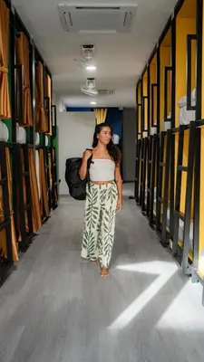 a woman walking down a hallway in a locker room at The highdogs hostel in Phi Phi Don