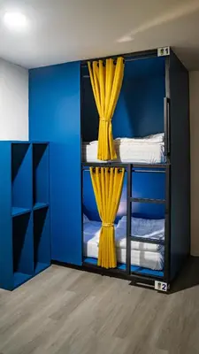 a room with two bunk beds with yellow curtains at The highdogs hostel in Phi Phi Don