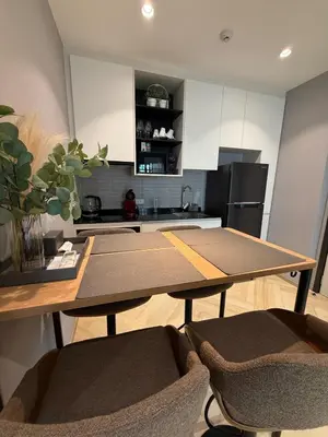 a kitchen with a table and two chairs in a room at New and Stunning 1BR, The Title Legendary by UNO in Bang Tao Beach
