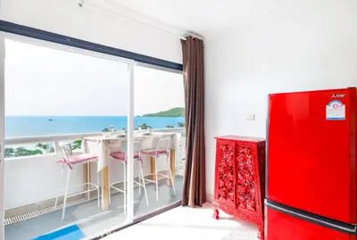 a red refrigerator in a room with a large window at OMNIAPHUKET - Sea View Patong Tower - Top Location & Sea View in Patong Beach