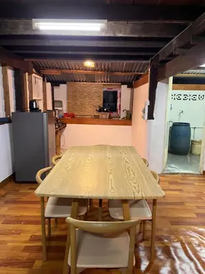 a table and chairs in a room with a kitchen at Balance home happy in Ko Yao Noi