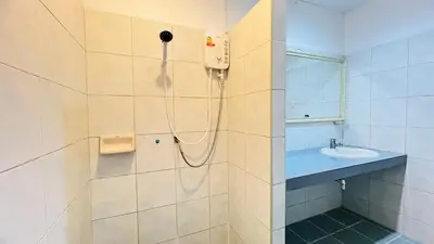 a bathroom with a shower and a sink at Daisy House Patong in Patong Beach