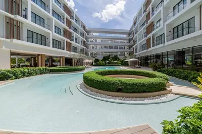 an apartment complex with a large courtyard with a fountain at Laya Resort 1 bedroom By Ere in Layan Beach