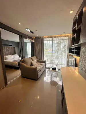 a living room with a couch and a bed at CityGate Kamala 1 bedroom by Ere B312 in Kamala Beach