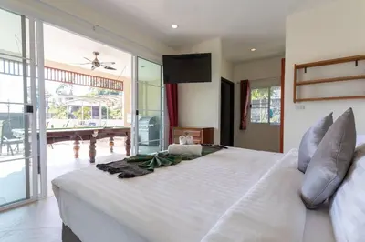 a large white bed in a room with a large window at Luxury Seaview Villa, Infinity Pool, Sunset in Karon Beach