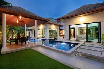 a villa with a swimming pool and a dining area at Tropical Dream Villa in Rawai Beach