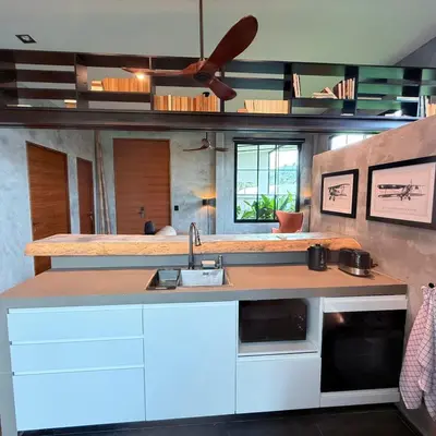 a kitchen with white cabinets and a sink at Sakhu Art Villa in Nai Yang Beach