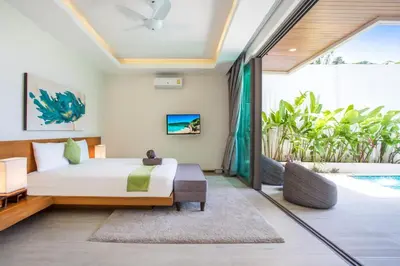 a bedroom with a bed and a pool at Private Pool 4BR Villa Kari next to Rawai Beach in Rawai Beach