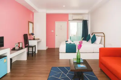 a living room with a bed and a couch at Chic Boutique Hotel, Patong in Patong Beach