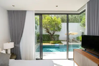 a bedroom with a view of a swimming pool at Villa Beautiful swimming pool in Phuket