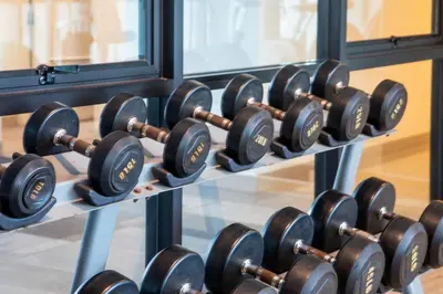 a row of dumbbells on a rack in a gym at Cozy room near beaches & restaurants in Bang Tao Beach