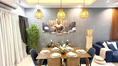 a living room with a table and a blue couch at Stylish Family Townhouse 3 Bdr in Chalong