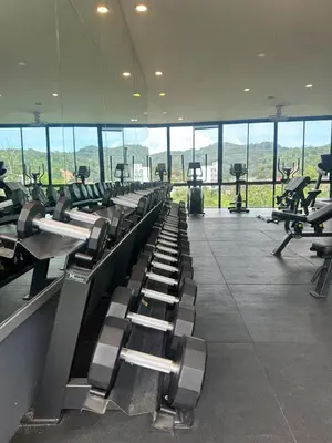a gym with a row of treadmills and machines at CityGate Kamala 1 bedroom by Ere L807 in Kamala Beach