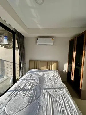 a bedroom with a bed in the middle of it at Hillside-Seashore Space Mai Khao Beach in Mai Khao Beach