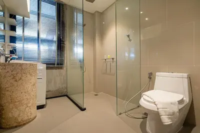 a bathroom with a toilet and a glass shower at Duplex Villa Natural Touch A2 2BR with scenic view and rooftop terrace in Kamala Beach