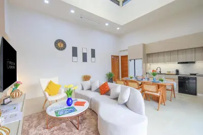 a living room with a couch and a table at Phirunda Pool Villas in Ban Suan