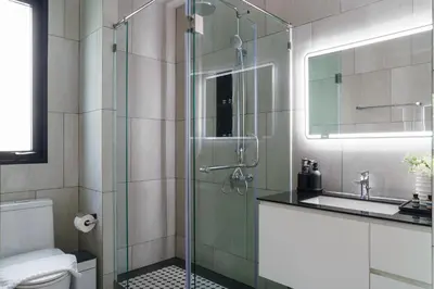 a bathroom with a glass shower and a sink at The Title Legendary Grand Pool Access in Bang Tao Beach