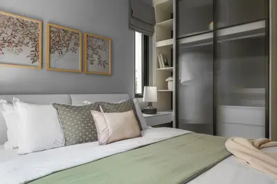 a bedroom with a large bed with white pillows at The Title Legendary Grand Pool Access in Bang Tao Beach