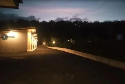 a building with a light on the side of a road at Sunisa Resort in Phuket Town