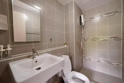 a bathroom with a sink and a toilet and a mirror at Valley Mountain View&City Proximity Golden Eight Apartment in Ban Phlu Yai