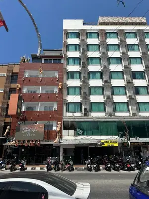 a large building with motorcycles parked in front of it at Grand Patong Apartment 7FL in Patong Beach