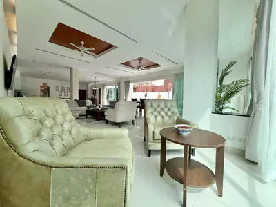 a living room with a couch and a table at Kamala Seaview - 3 BR Private Pool Villa in Kamala Beach