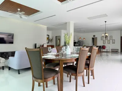 a dining room with a table and chairs at Kamala Seaview - 3 BR Private Pool Villa in Kamala Beach