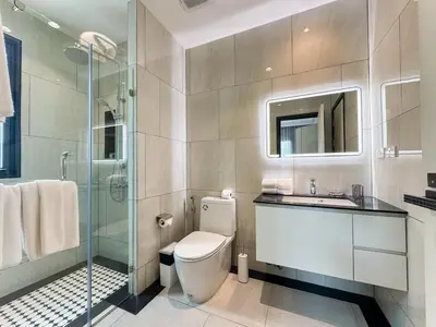 a bathroom with a toilet and a sink and a shower at Family Title Legendary 2Bdr Bang Tao in Bang Tao Beach