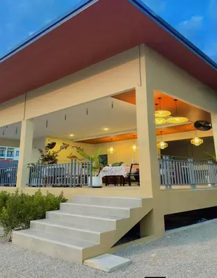 a house with a staircase leading to a patio at La La Lay Beach House in Tab Kaek Beach