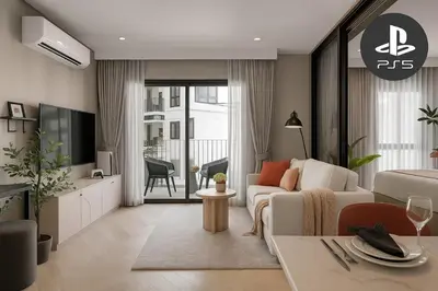 a living room with a white couch and a tv at Cozy 1 Bdr Title Legendary Bang Tao 5 min to the Beach in Bang Tao Beach