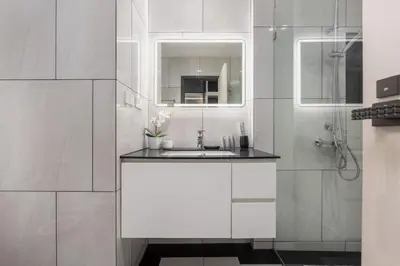 a white bathroom with a sink and a mirror at Oliva 1BR Suite — The Title Legendary BangTao in Bang Tao Beach
