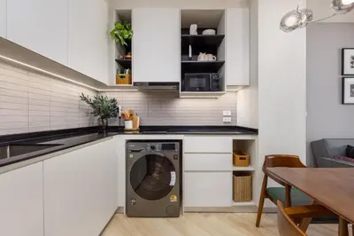 a kitchen with a washing machine in a white kitchen at Oliva 1BR Suite — The Title Legendary BangTao in Bang Tao Beach