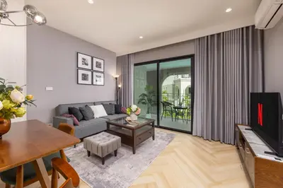 a living room with a couch and a table at Oliva 1BR Suite — The Title Legendary BangTao in Bang Tao Beach