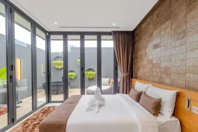a bedroom with a large bed and glass walls at V263 Brand New 3BR Super Modern Pool Villa - Calathea in Thalang