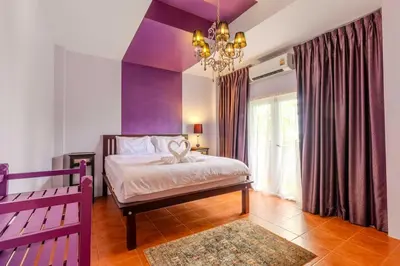 a bedroom with purple walls and a bed and a chandelier at V265 2BR Pool Villa Near Fitness Gyms Muay Thai in Ban Saiyuan (1)