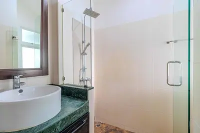 a bathroom with a sink and a glass shower at V267 Newly Renovated 2BR with Pool Near Beaches in Ban Saiyuan (1)
