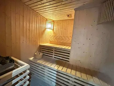 a wooden sauna with a bench in a room at The Privilege by Tris in Patong Beach