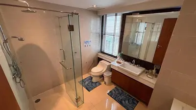 a bathroom with a shower and a toilet and a sink at The Privilege by Tris in Patong Beach