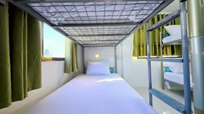 a small room with a bed and bunk beds at MT Friend Hostel Phuket Town in Phuket Town