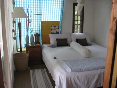 a bedroom with a bed with white sheets and pillows at Lanlay Home Stay Krabi in Ao Luk