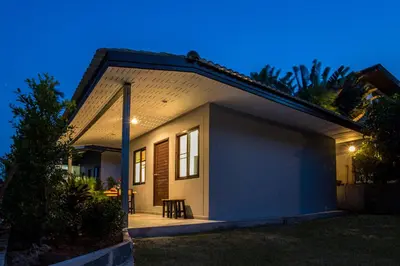a small house with a patio at night at Oxavia Garden Bungalow B1 -B2 Nai Harn in Rawai Beach
