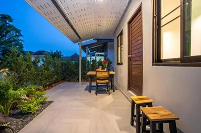 a patio with a table and chairs on it at Oxavia Garden Bungalow B1 -B2 Nai Harn in Rawai Beach