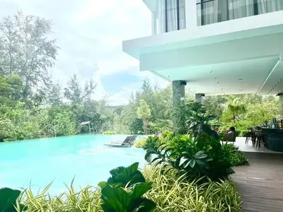 a large swimming pool in a building with trees at C243 1BR with Sofabed 5 Min Walk to Beach Pool&Gym in Thalang