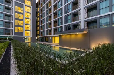 an apartment building with a swimming pool in front of it at C246 New 1BR Condo with Pool, Gym &Great Location in Thalang