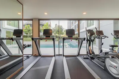 a gym with two treadmills and cardio machines at C246 New 1BR Condo with Pool, Gym &Great Location in Thalang