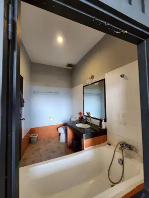 a large bathroom with a tub and a sink at The Rest Phuket in Phuket Town