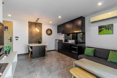 a kitchen and living room with a couch and a table at C248 Condo 3 Min to Nai Harn Beach 1BR with Rooftop Pool in Rawai Beach