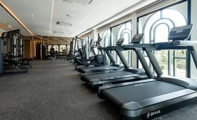 a row of treadmills in a gym with windows at C249 Brand new Pool view stay with great amenity in Bang Tao Beach