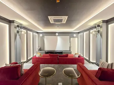 a living room with red couches and a screen at C249 Brand new Pool view stay with great amenity in Bang Tao Beach
